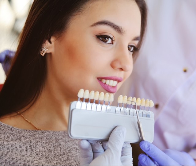 Woman having smile shade matched for cosmetic dentistry in Asheville