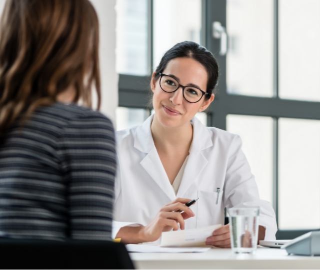 Talking to dental patient at a desk