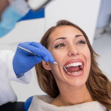 Woman in dental chair having teeth examined