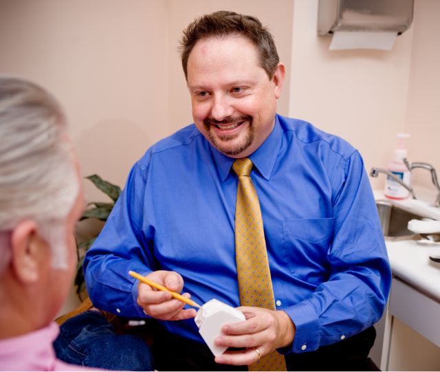 Doctor John White talking to a patient