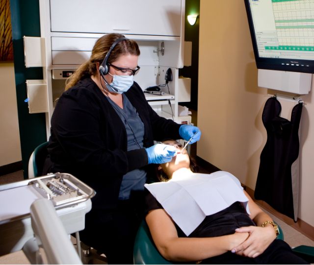 Female dental team member working on patients smile