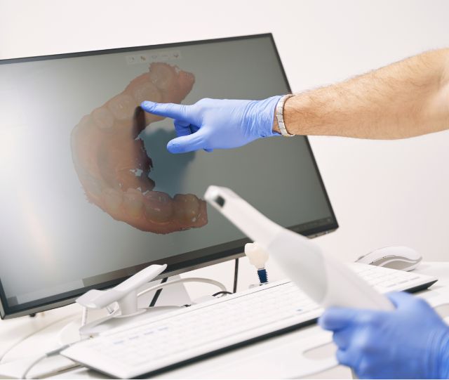 Pointing to virtual model of teeth on monitor