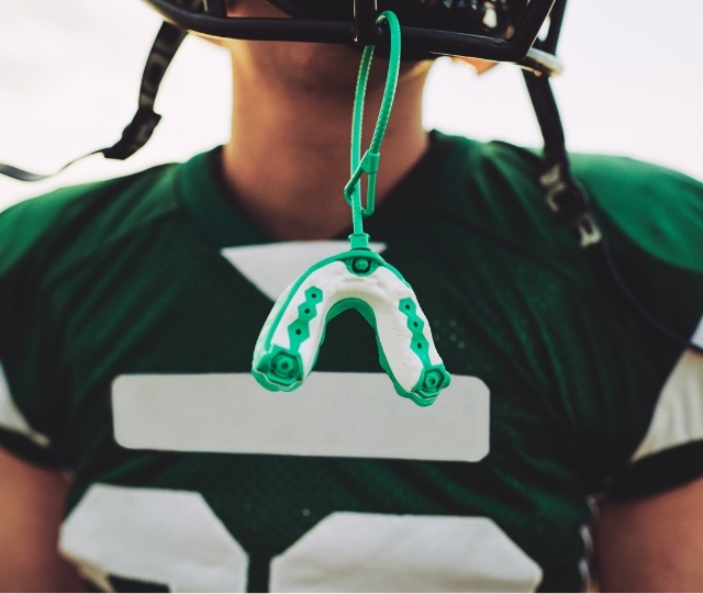 Mouthguard dangling off a football helmet